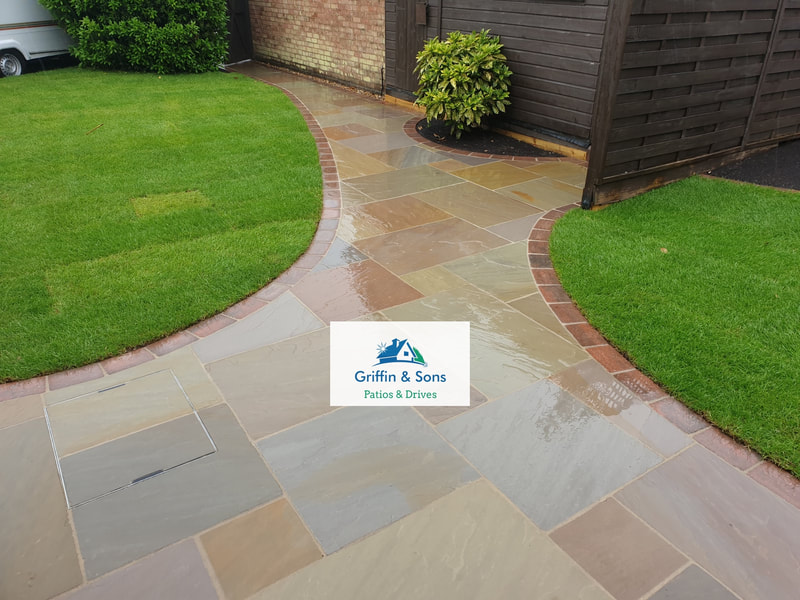 Forest Glen Indian Sandstone Patio finished with a Brindle Alpha paving brick and freshly laid turf